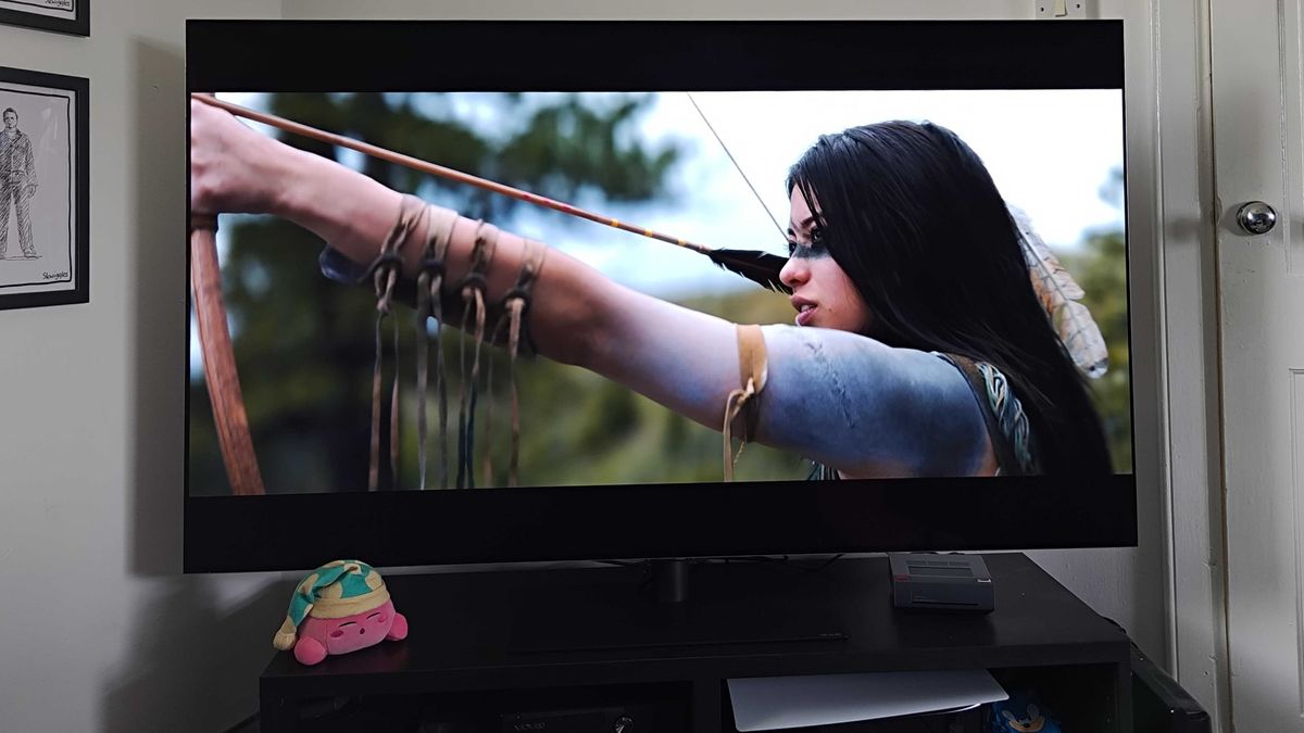 LG OLED G4 with Naru from film Prey on screen ready to shoot arrow