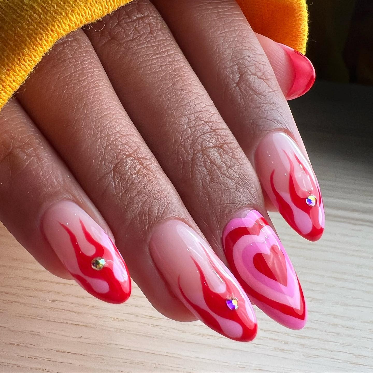 Pink and red flame nail art with hearts