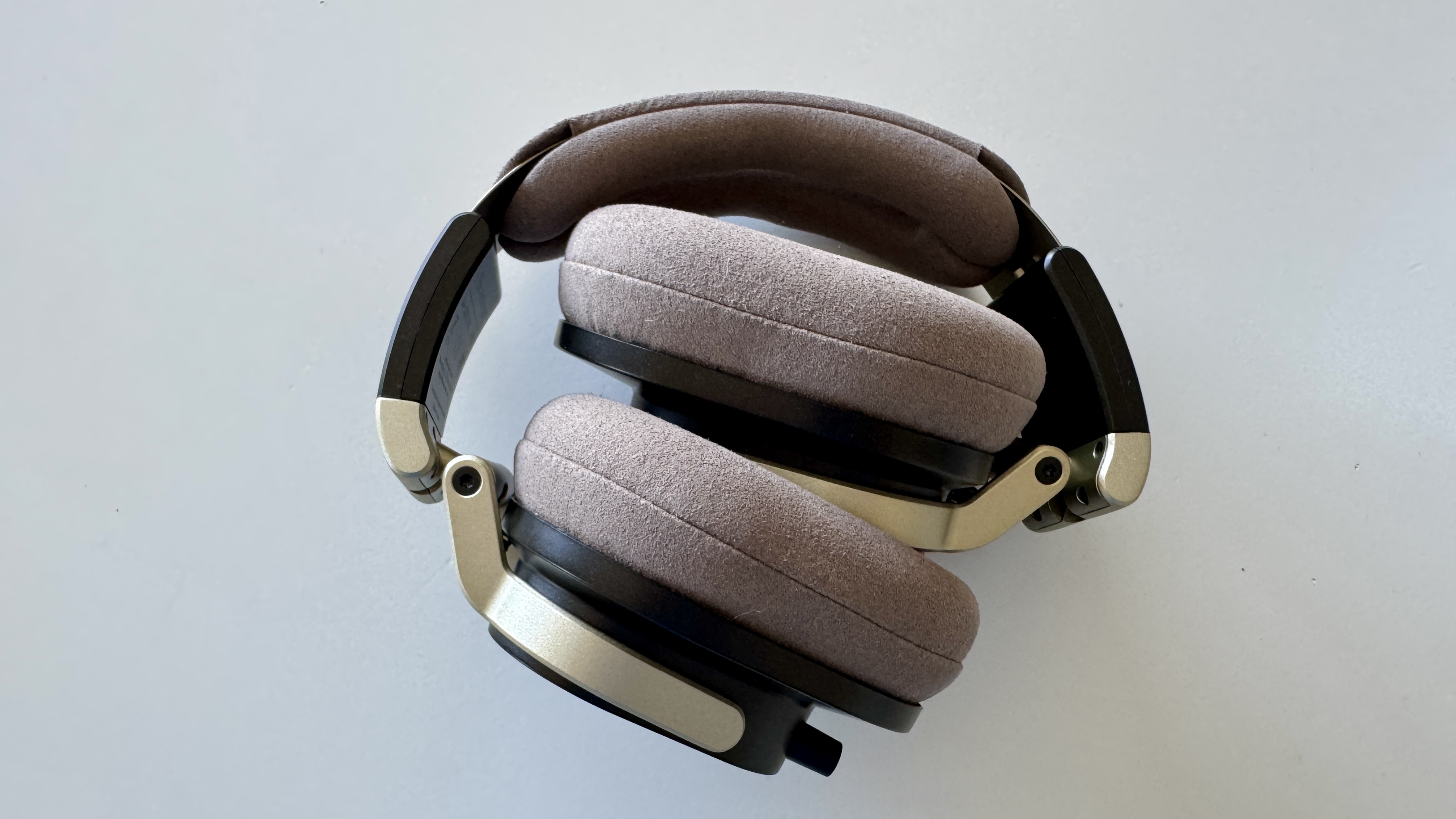 Austrian Audio The Arranger open-backed headphones, folded together, on a white background.