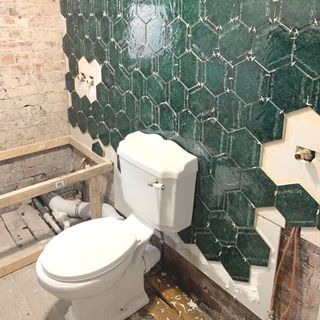 partially tiled bathroom in renovation project.jpg
