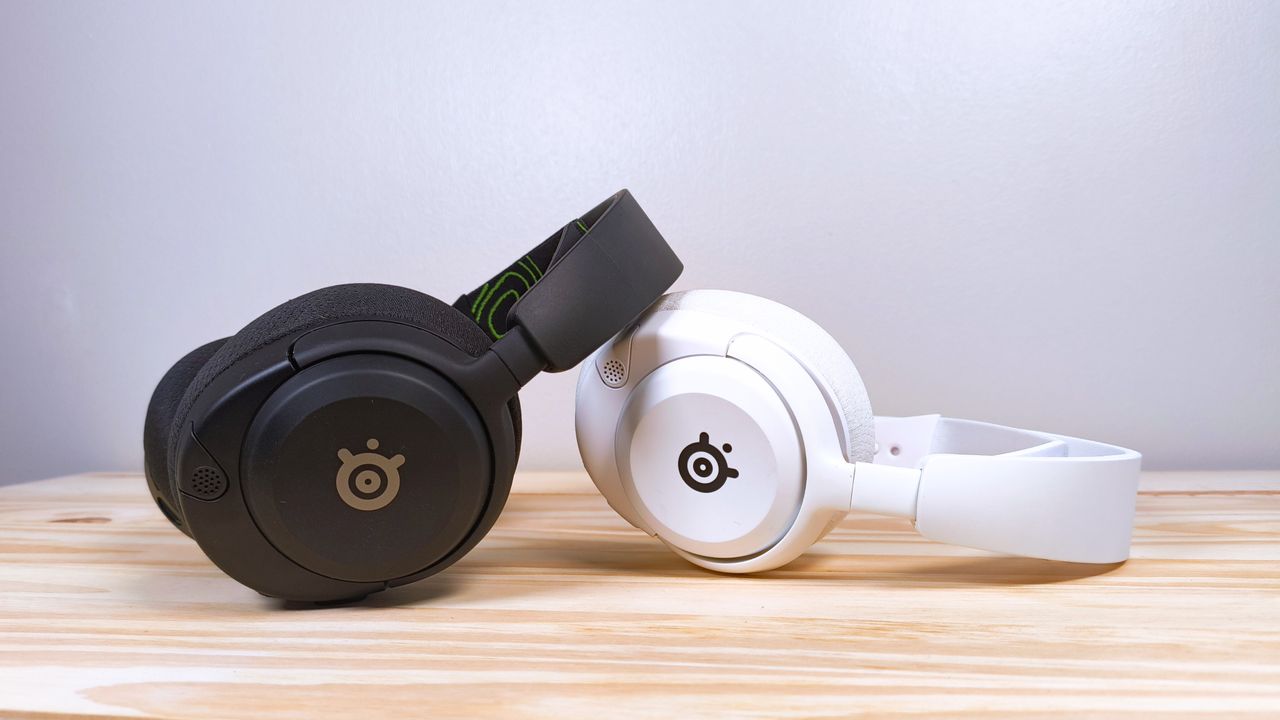 Two pairs of the SteelSeries Arctis Nova 5X in black and white laying on a wood table