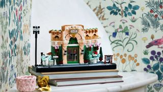 Lego French Café on a pile of books, against a floral background