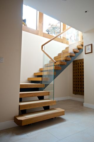glass and wood staircase unit in hallway