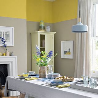 dining room with cream storage neutral and yellow walls and blue touches