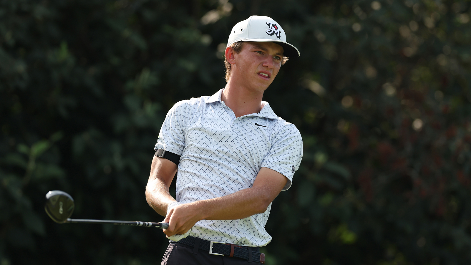 Miles Russell hits a fairway wood