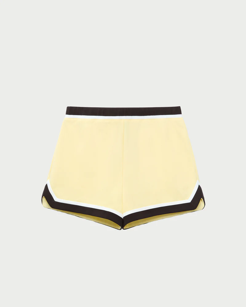 Butter yellow track shirts with black trim.
