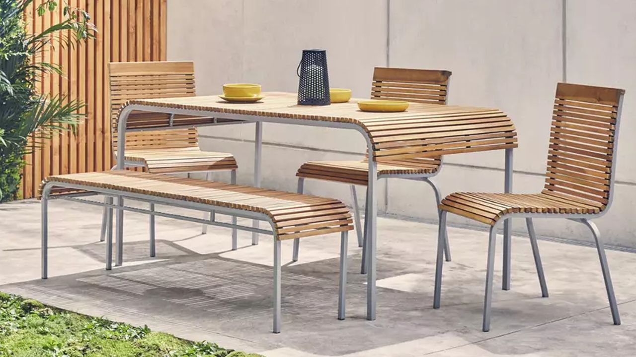 A wooden slatted outdoor dining table and chair set