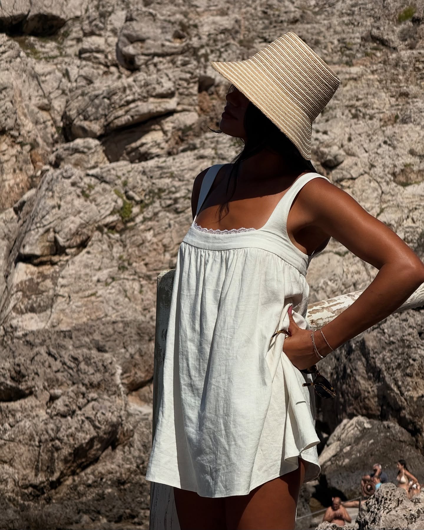 Content creator Michelle Infusino in a white dress and straw hat.
