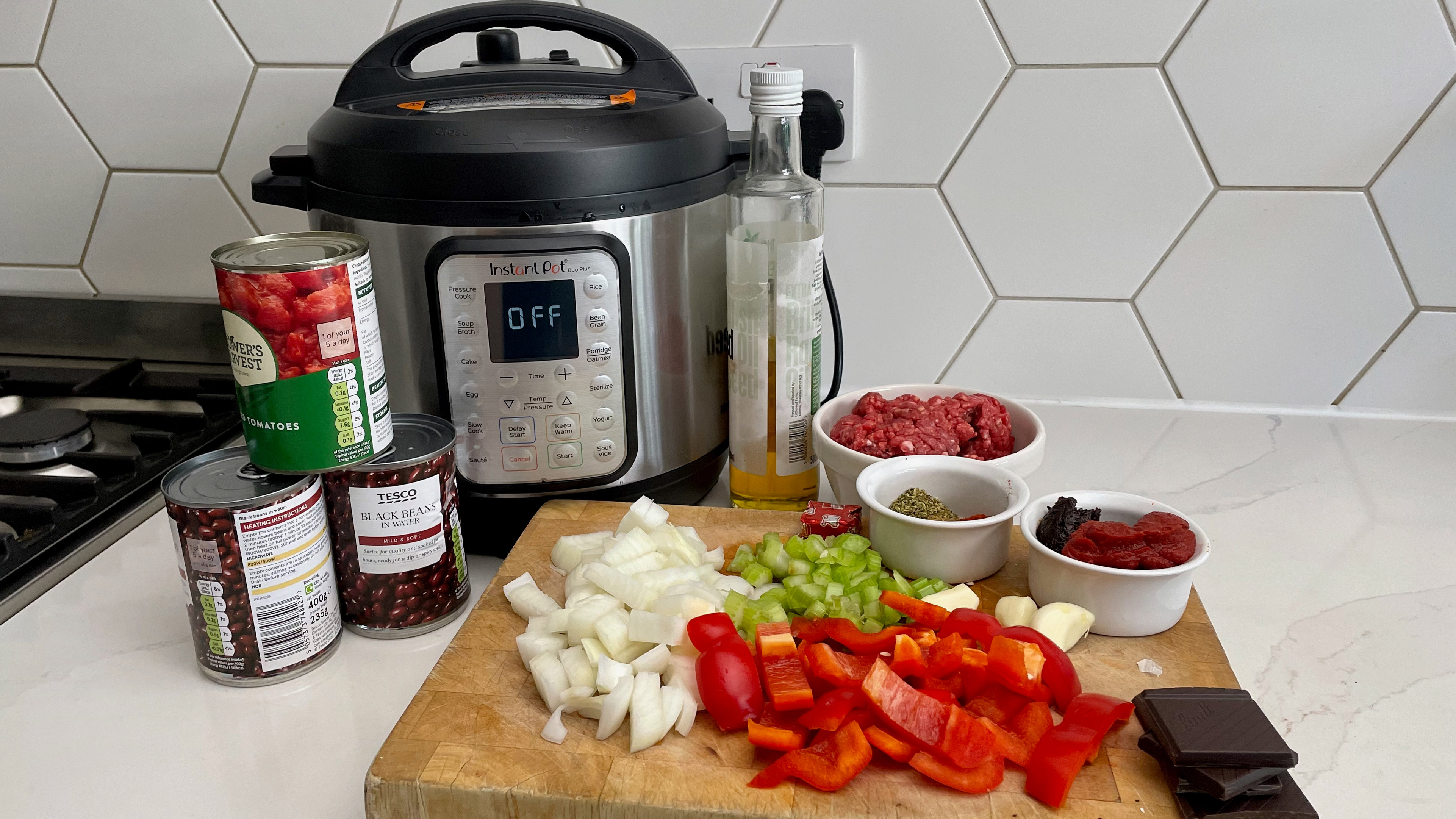 The Instant Pot Duo Plus alongside the ingredient for a slow-cooked beef chilli