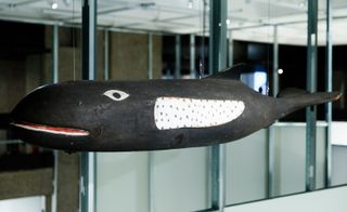Hanging above the art gallery's staircase is a wooden whale, which the designers kept in their studio throughout the years.