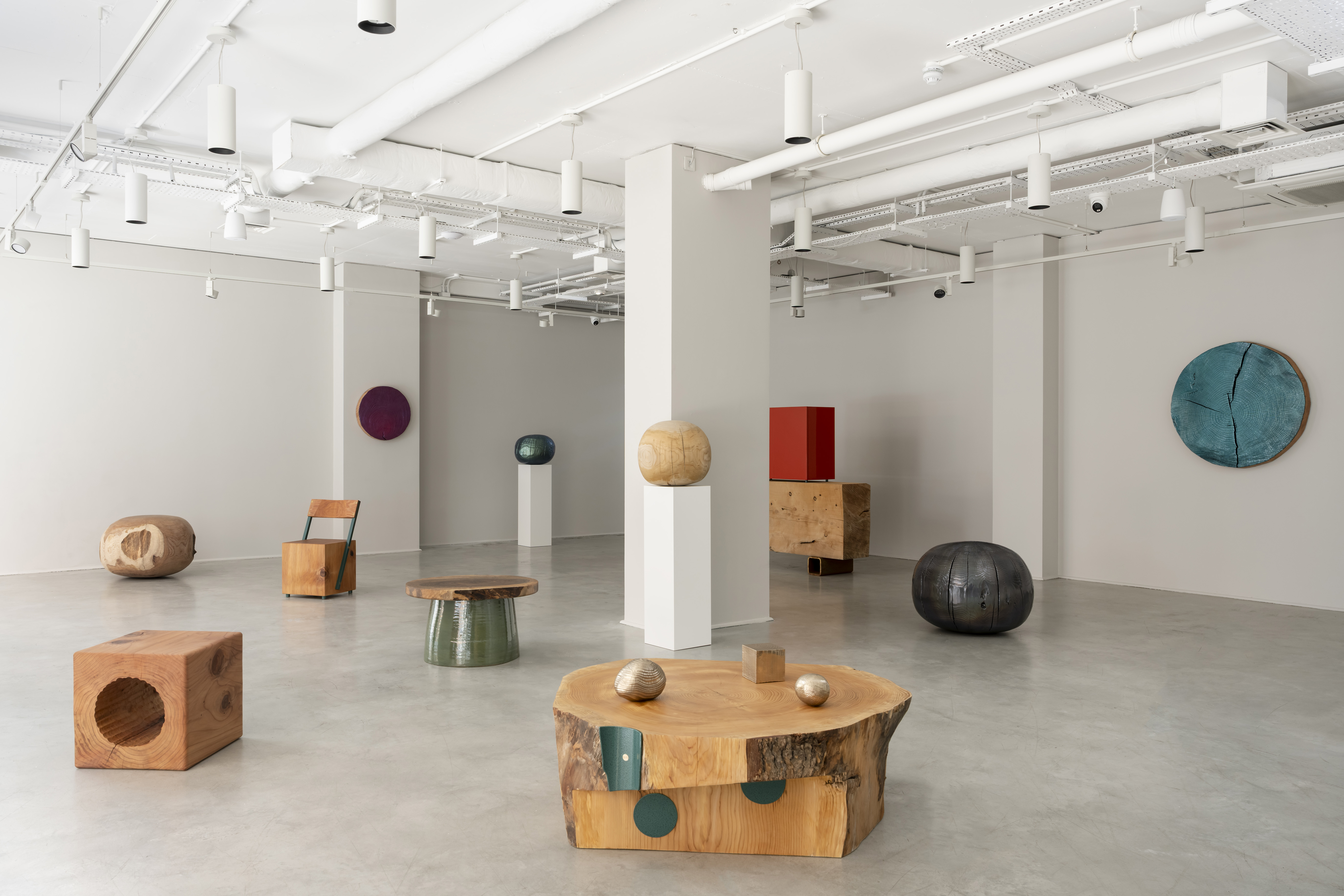 tables and chairs and spherical objects inside gallery fumi, london