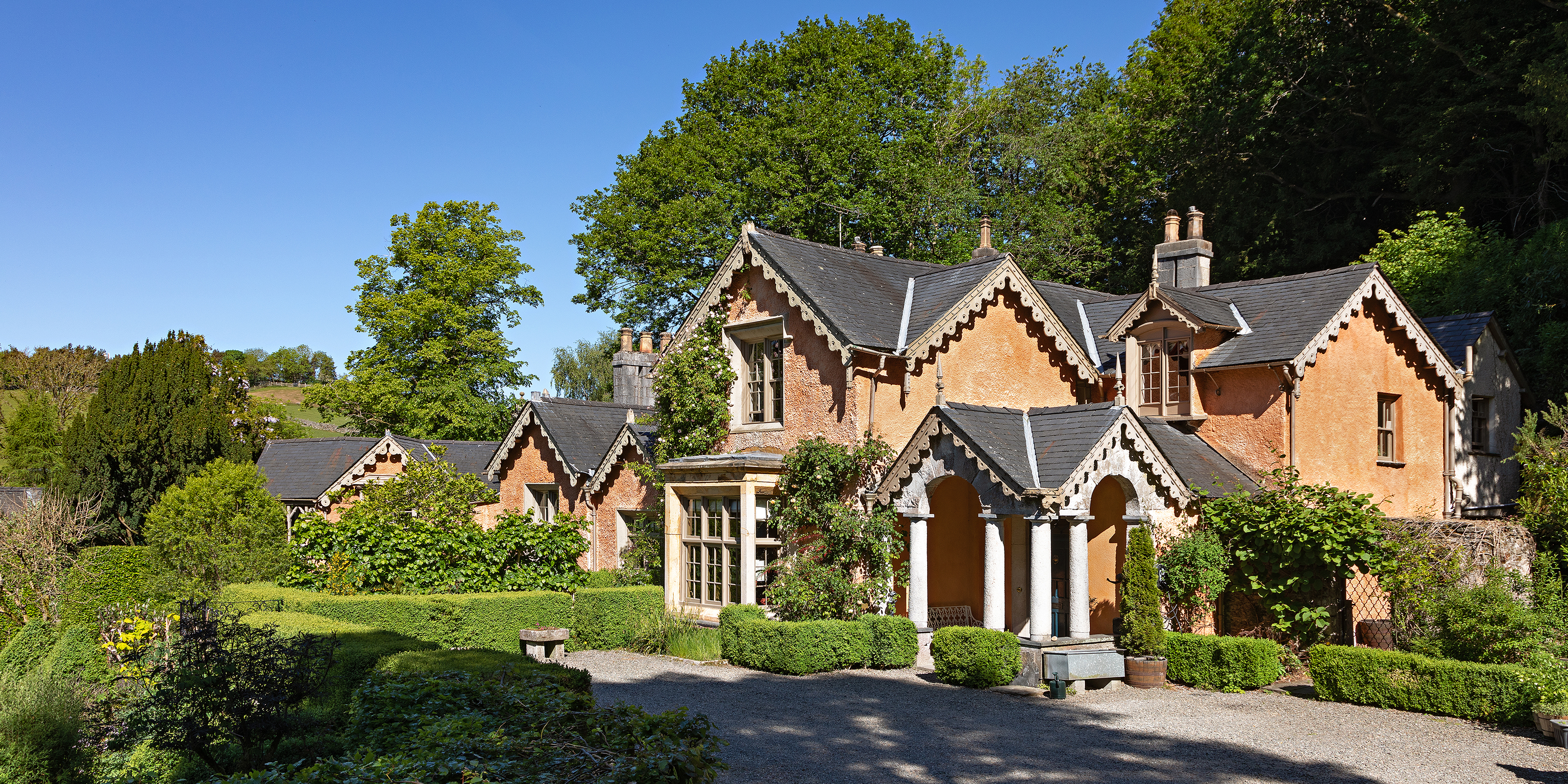 exterior of a large regency property with ornate porch and Jacobean and Elizabethan elements