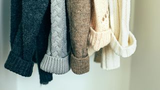 Hanging up jumpers in the wardrobe - Getty - 1277960838