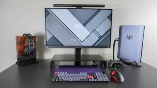 A desk setup built around the Razer Monitor Stand Chroma with the stand on top