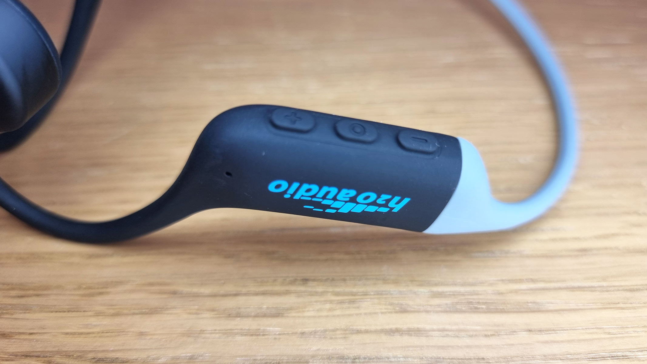 a close-up picture of the logo on the H20 Audio Tri Run headphones