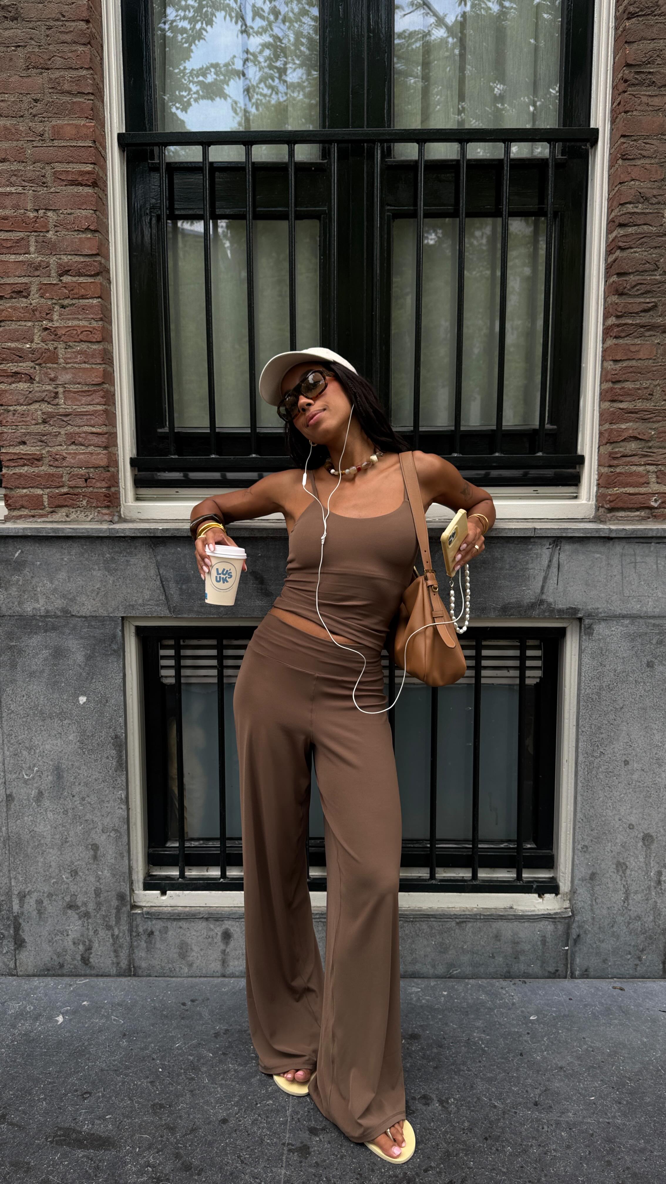 An image of @amaka.hamelijnck wearing flared leggings in chocolate brown, one of the biggest leggings trends for 2026.