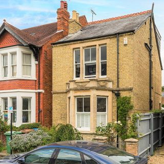 Minster Road exterior house with bay windows and traditional brick exterior with small garden with a blue car parked in front of the house