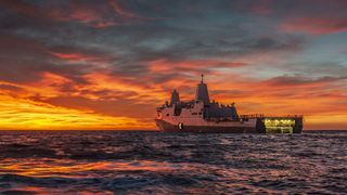 A sunset shot of the USS John P. Murtha during recovery test procedures for NASA's Orion crew capsule.