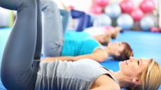 women on yoga mats doing tabletop pose
