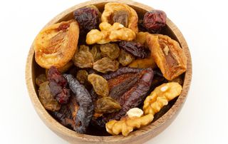A bowl of walnuts and dried fruit