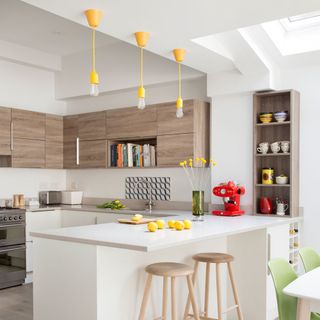 kitchen with yellow hanging lamp and wooden cabinet