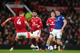 Manchester United's Matthijs De Ligt and Bruno Fernandes battle for the ball with Ipswich Town's Liam Delap during the Premier League match at Old Trafford on 26 February, 2025