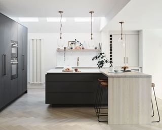 Black and white l-shaped kitchen with white walls