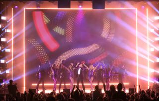 Donny Osmond is illuminated in bright purple and blue lasers and lights at his Las Vegas residency.