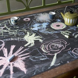 chalkboard dining table with kettle