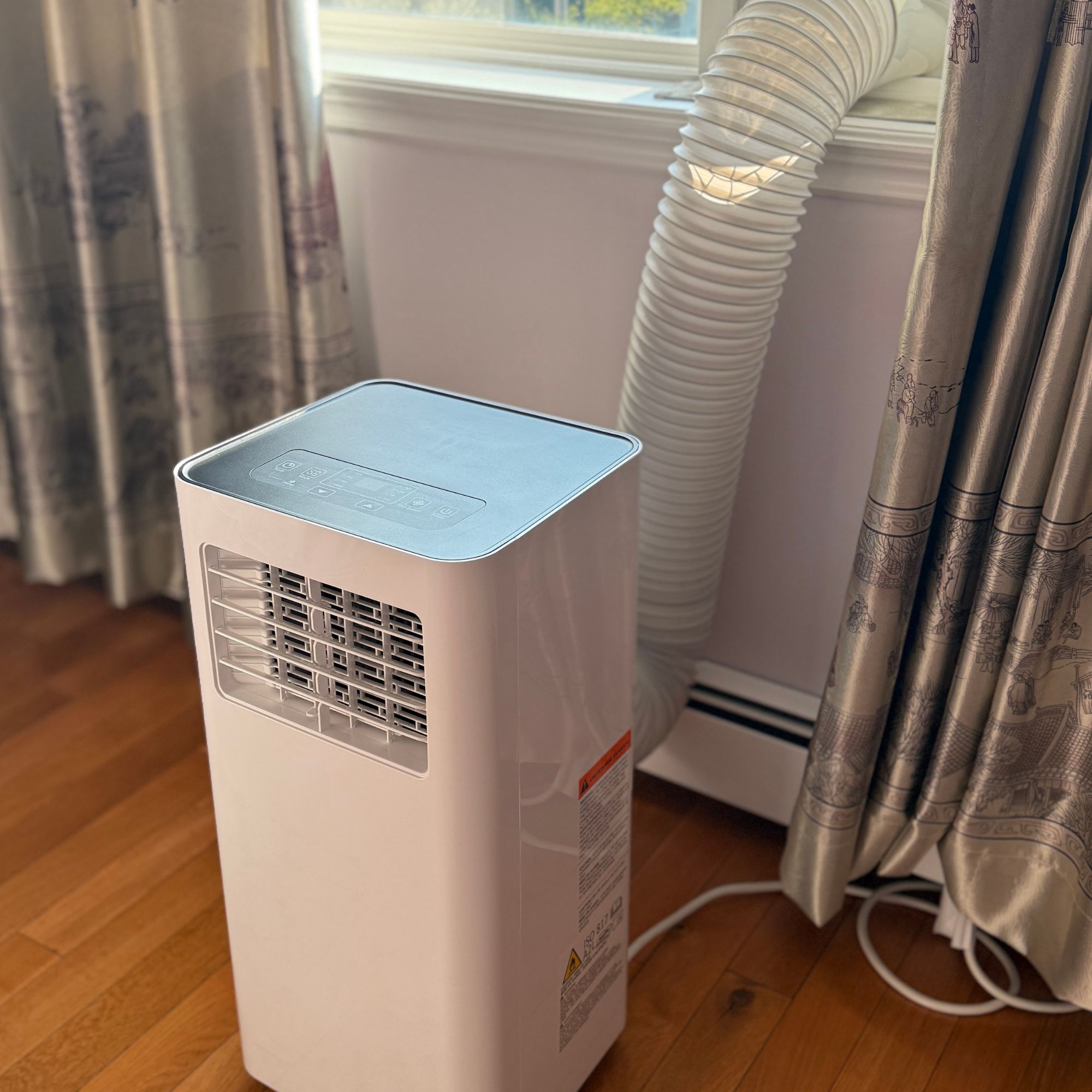 Portable air conditioner with exhaust tube vented out of a window