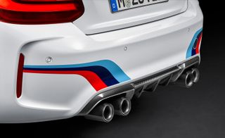 The reat of the M2 featuring a red, black and blue stripe on the car's boot.