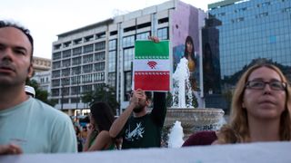 A protester holds a sign about imposing an internet blackout in Iran during a demonstration in Athens