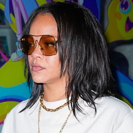 Rihanna wore an oversize white T-shirt with the white jeans trend and high-vamp flats
