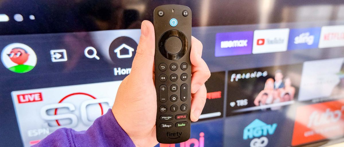 The Alexa Voice Remote Pro in hand in front of a TV