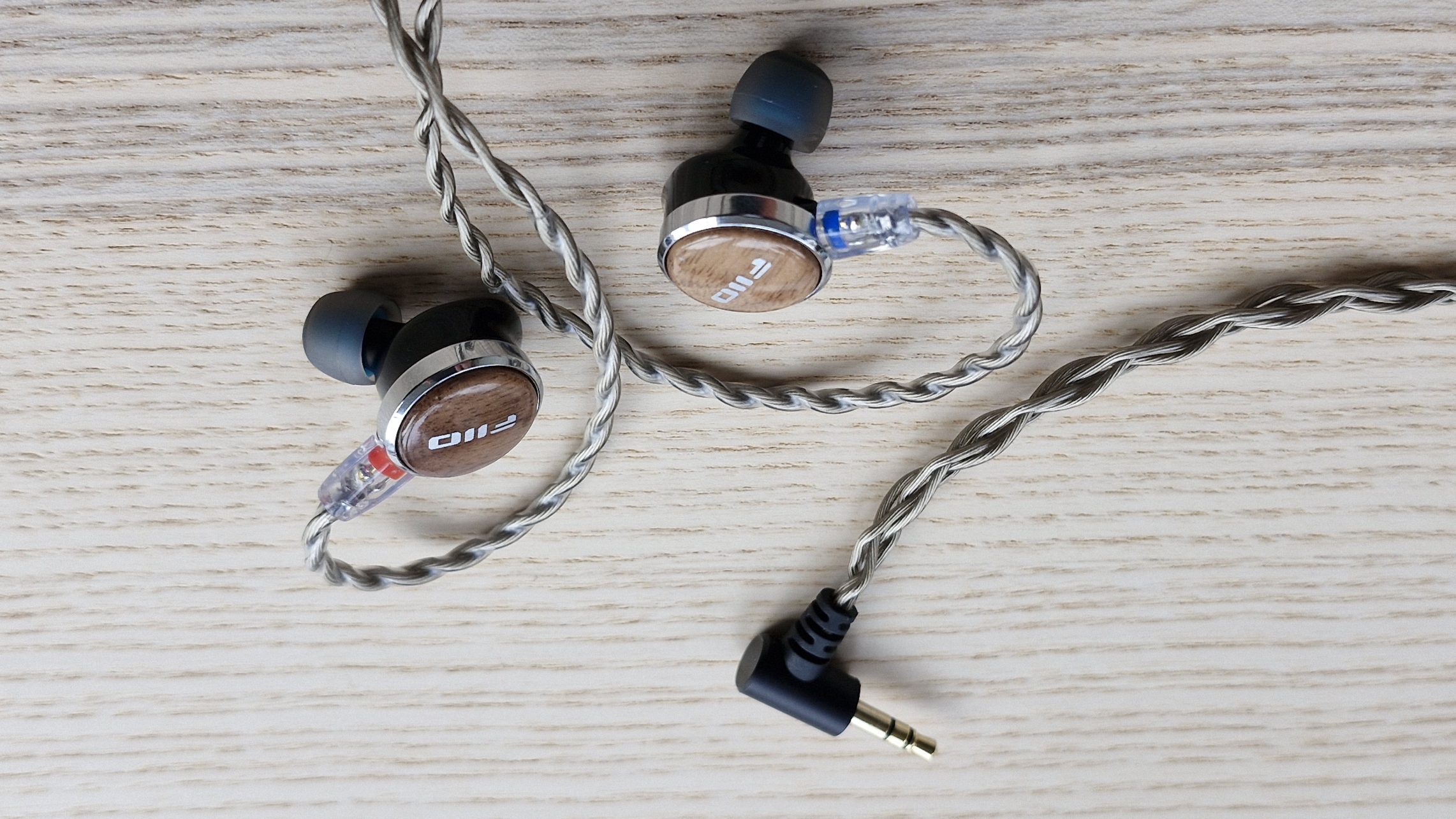 FIIO FP3 wired earplugs on wooden surface