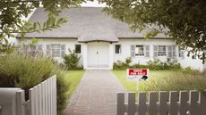 A house with a for sale sign in front.