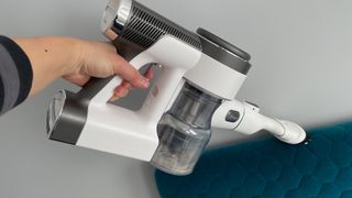 The Tineco Pure One S12 Pro EX being used in handheld mode to clean upholstry