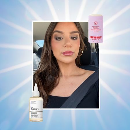 a girl in a car with long brown hair and gold hoops on a sunlit background next to a purple chafing stick and a bottle of glycolic acid skincare