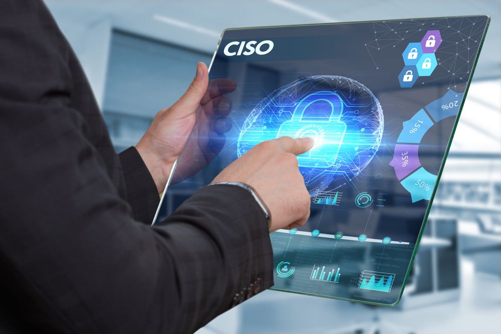 A businessman working on a futuristic tablet that is displaying the word &amp;#039;CISO&amp;#039;