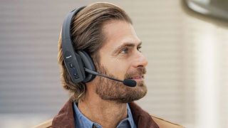 Man wearing BlueParrott B450-XT Bluetooth headset.