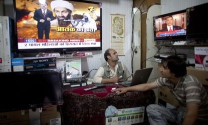 Afghan men watch the news of Osama bin Laden's death. The al-Qaeda leader's death is "like a lifting of a curse" for the muslim world, says an Arab News editorial.