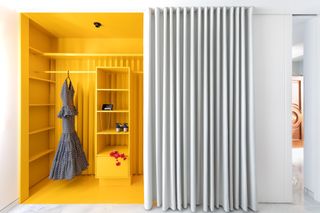 A closet with yellow interiors