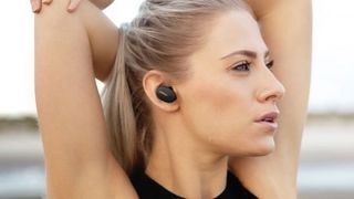 Bose sport earbuds worn by woman exercising