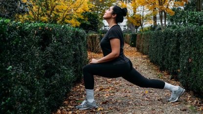 Woman stretching out hips in park