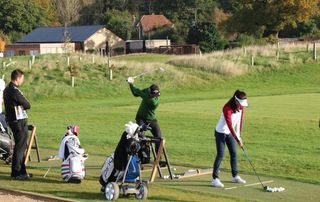 Alex Saary on the practice ground with Marco Penge and Sophie Lamb