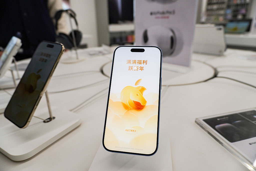 An iPhone with a Lunar New Year-themed lock screen seen displayed on a stand in an Apple authorized store at Baolong Mall in China
