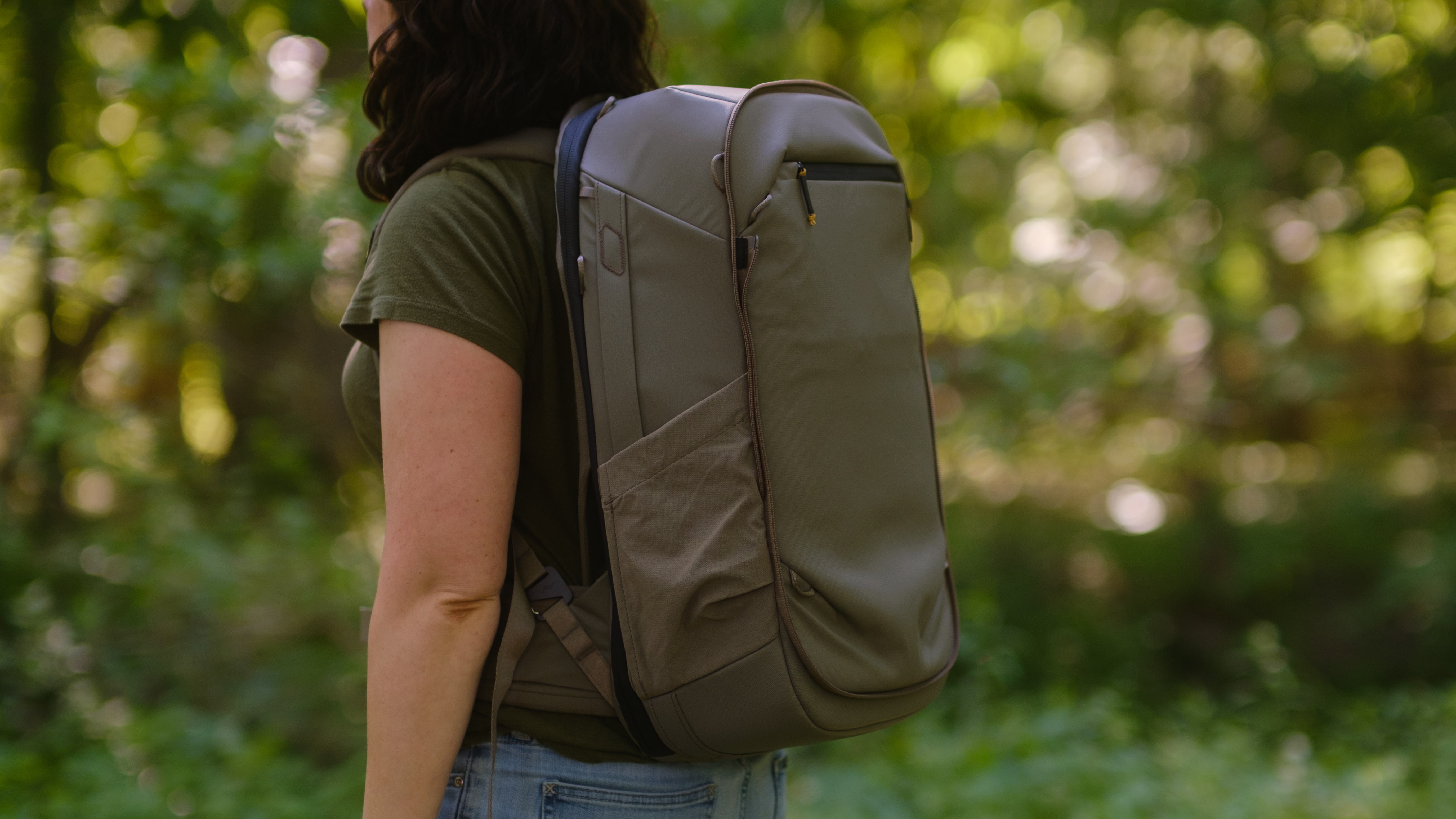 The Peak Design Travel 2-in-1 Backpack outdoors used by a photographer