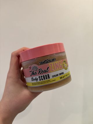 Mica Ricketts holding Soap & Glory The Real Zing Body Scrub