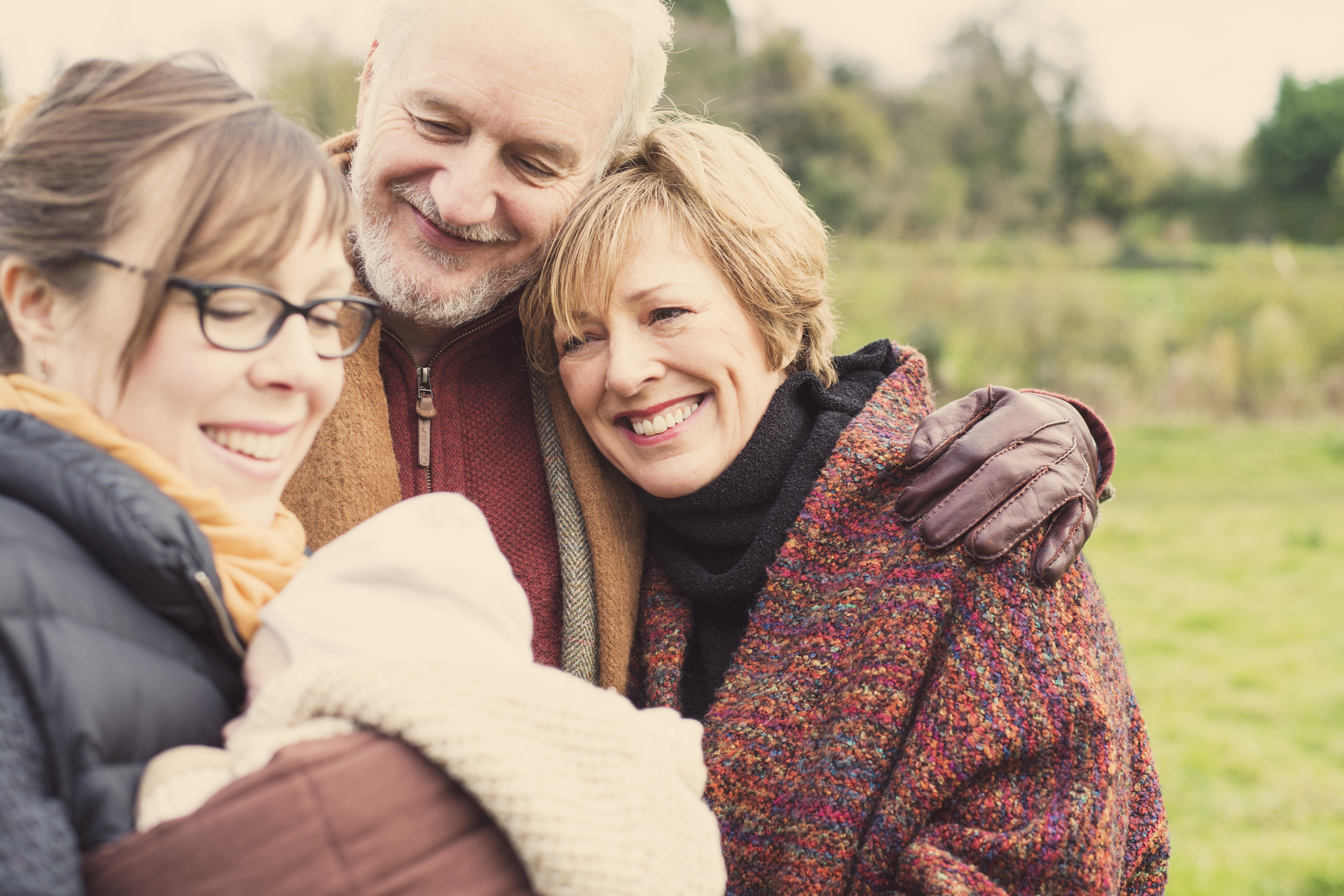 Mother holding baby son, with grandparents