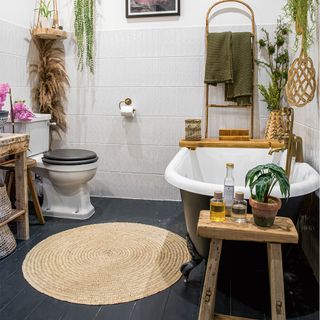 bathroom with cast iron bath and wooden stool